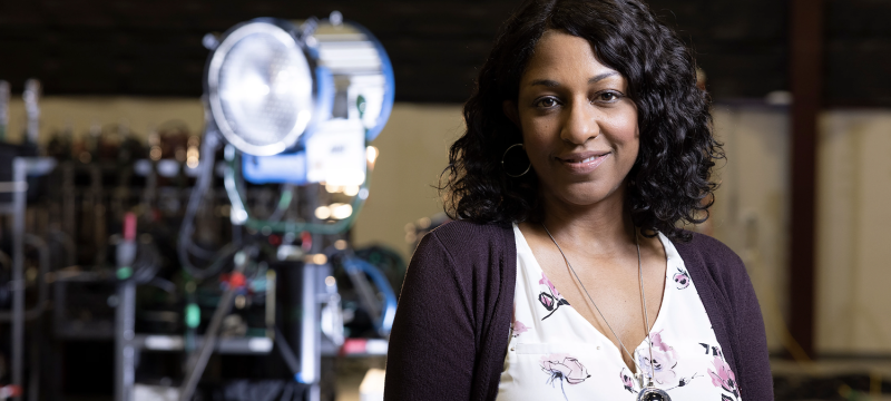 photo of woman, with lighting rig in background