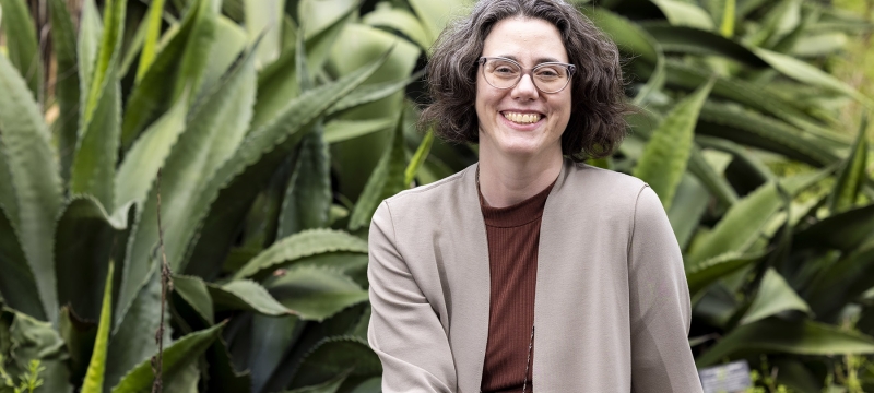 photo of woman with garden in background, day 