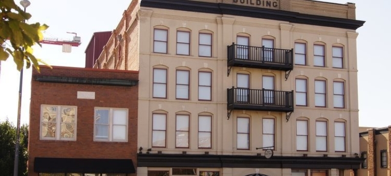 Photo of four-story building, day