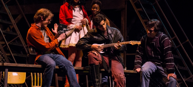 photo of five actors on stage in performance 