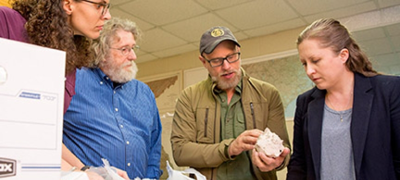 four people with shell, interior photo
