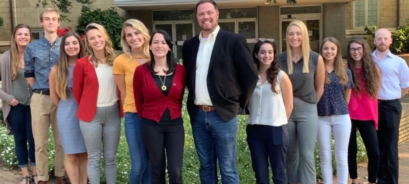 group photo of men and woman outdoors