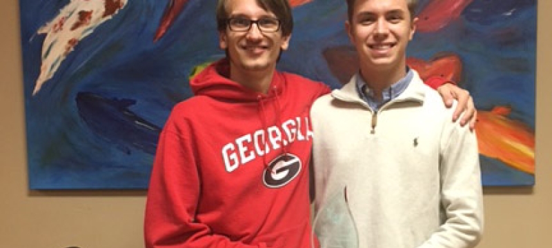two students in front of a painting