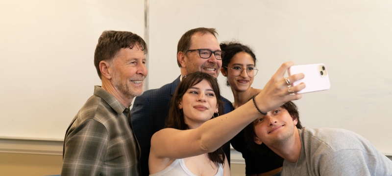 photo of five people taking a selfie