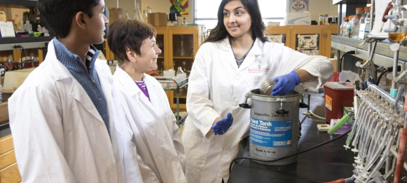 photo of three people in laboratory, with white lab coats