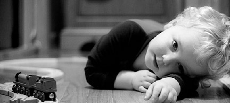 child in b/w with trains 