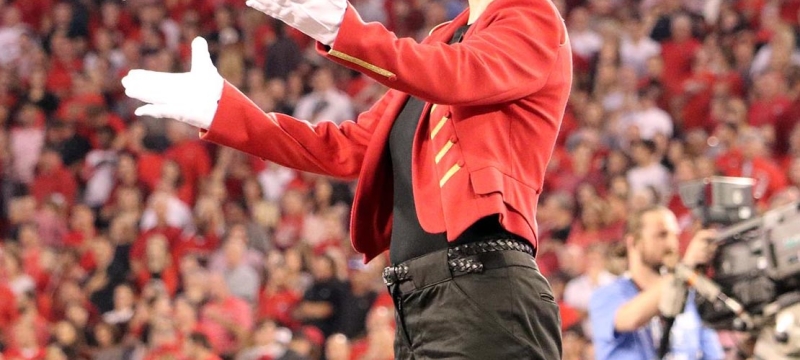 photo of conductor on platform at sporting event