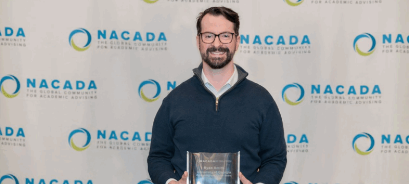 photo of man holding plaque