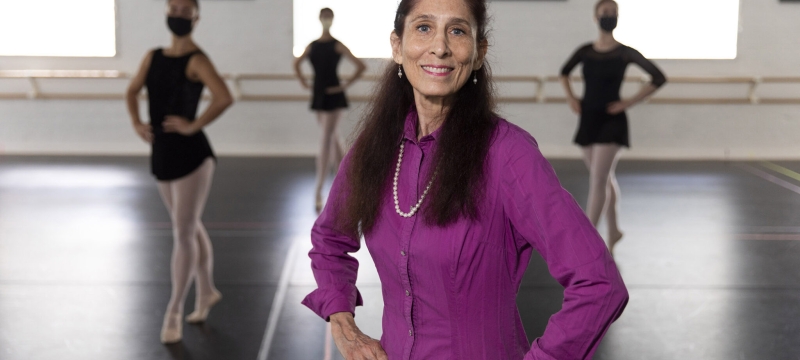 photo of woman in studio, with dancers in background