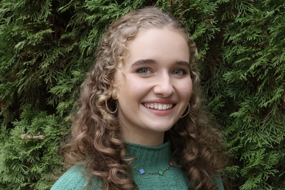 photo of woman, green foliage in background