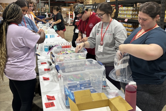 photo of people packing supplies in warehouse