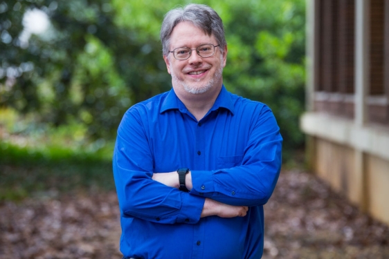 photo of man in blue shirt, outdoors