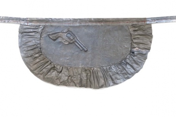 metal sculpture of apron with pistol