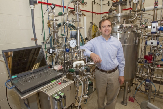 photo of man with fermentation equipment