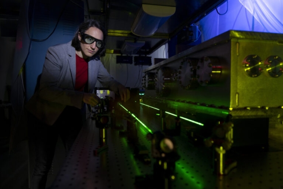 photo of woman in lab with laser