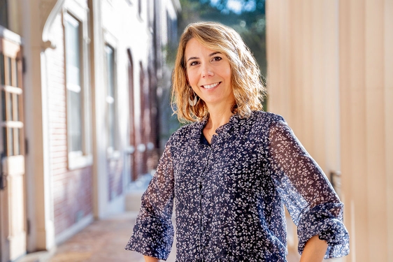 Photo of woman on building porch, day