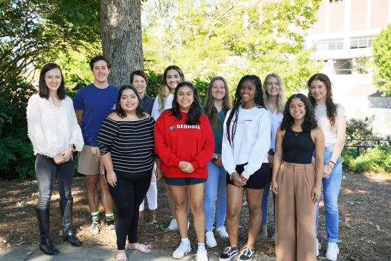 photo of group of people, outdoors, tree in background