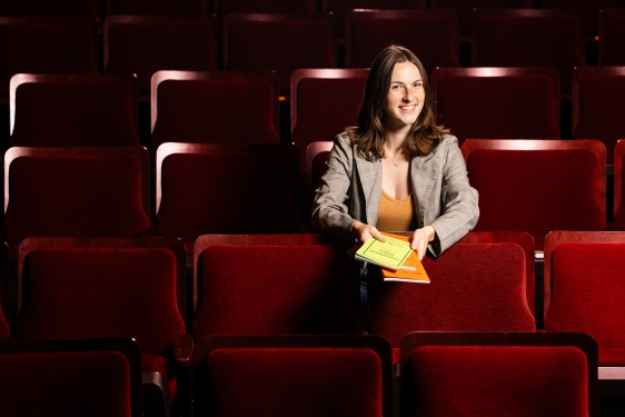 photo of woman sitting in theatre seats