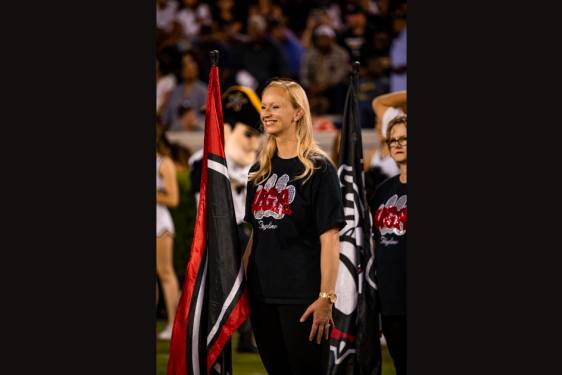 photo of woman on field, with flag