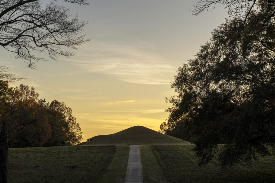 photo of earth mound, covered with grass, twilight