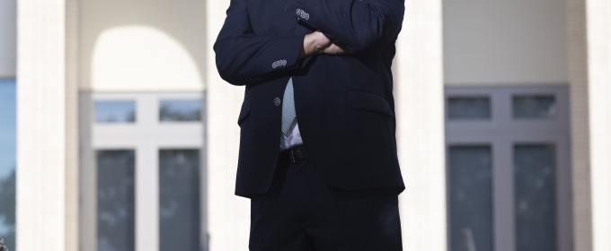 photo of man in front of building, day