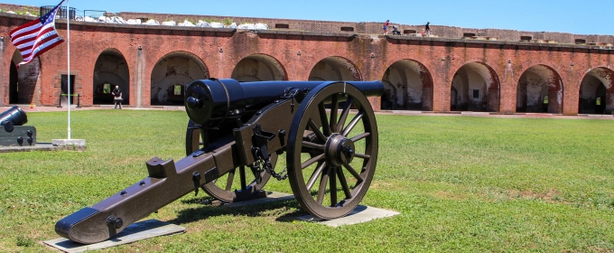 photo of interior of old fort, with cannon and grass