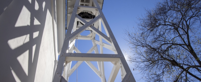 photo of bell tower and blue sky from below 