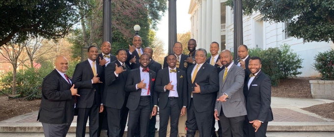 photo of men in suits in front of Arch, day