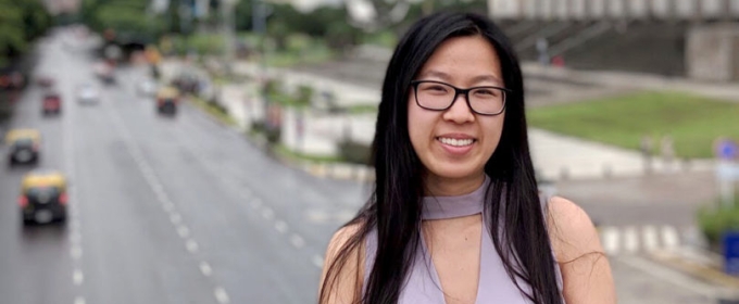 photo of woman outdoors on bridge over highway