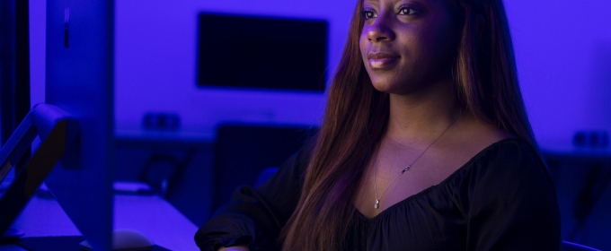 photo of woman at computer, blue tint background