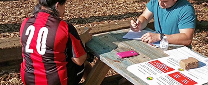 man and woman at table outdoors