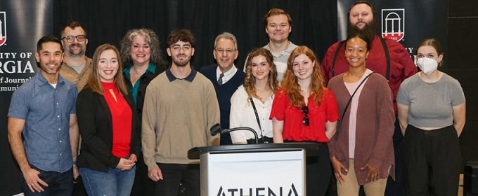 group photo of people behind podium