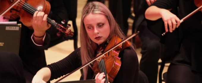 photo of woman playing viola, with other musicians