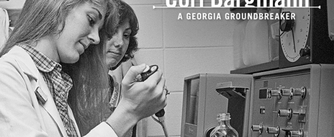 black and white photo of two people in a lab, woman in foreground 