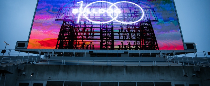 photo of stadium sign illuminated at twilight