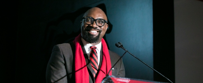 photo of man speaking at podium