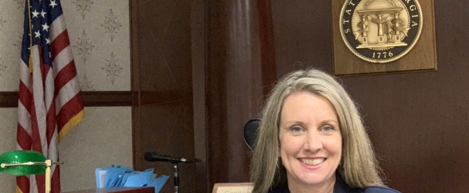 photo of woman, wait flag and state seal in background