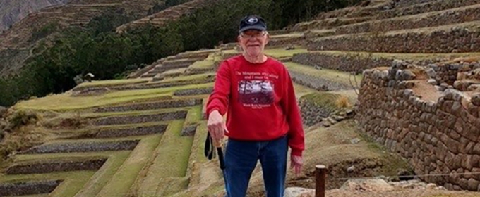 photo of man, ancient terraces in background, day