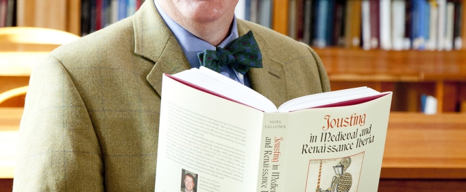 photo of man with book and book shelves