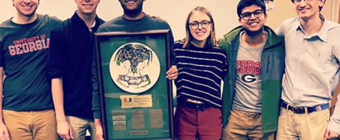 photo of five students with plaque 