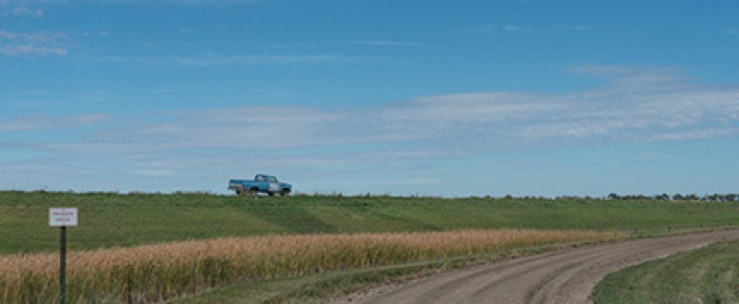 truck in a field, with sky