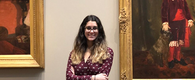 photo of woman with framed paintings