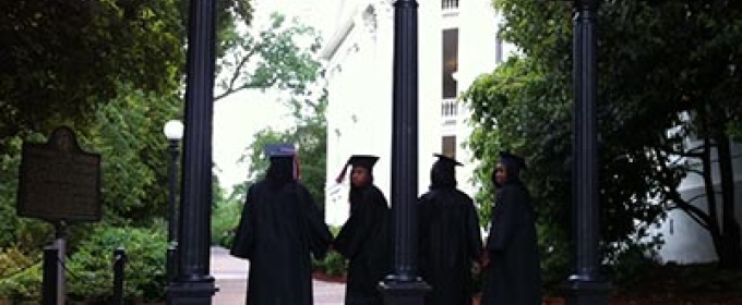 caps and gowns at the arch