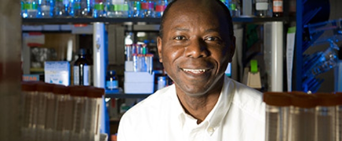 man in lab with bottles