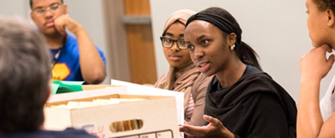 photo of people with file box in discussion