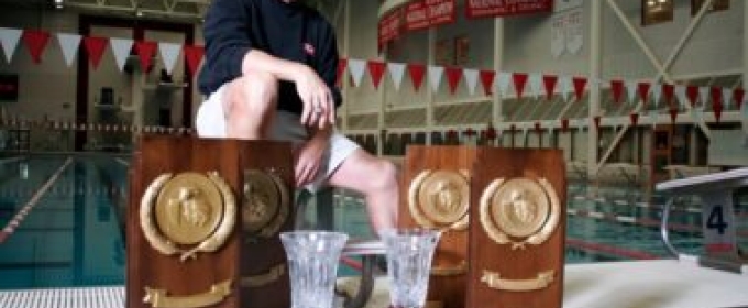 photo of many with trophies and plaques, with pool