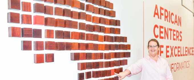 photo of woman standing next to outline of Africa