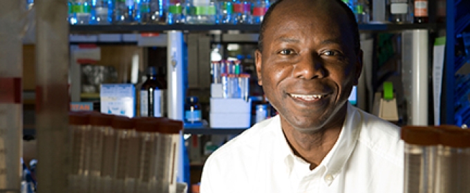 man in lab with beakers, bottles