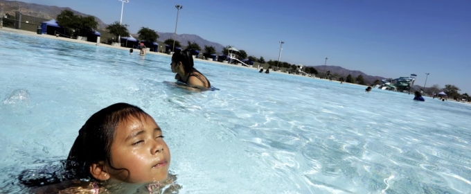 photo of woman and child in pool, day