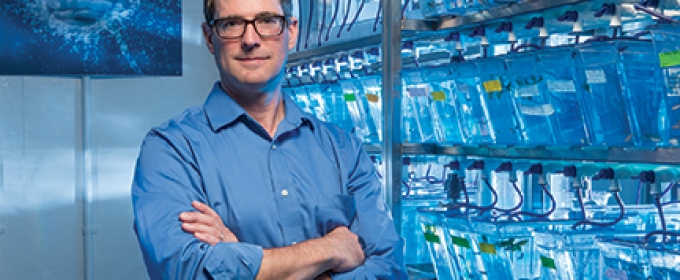 man in lab with blue lights